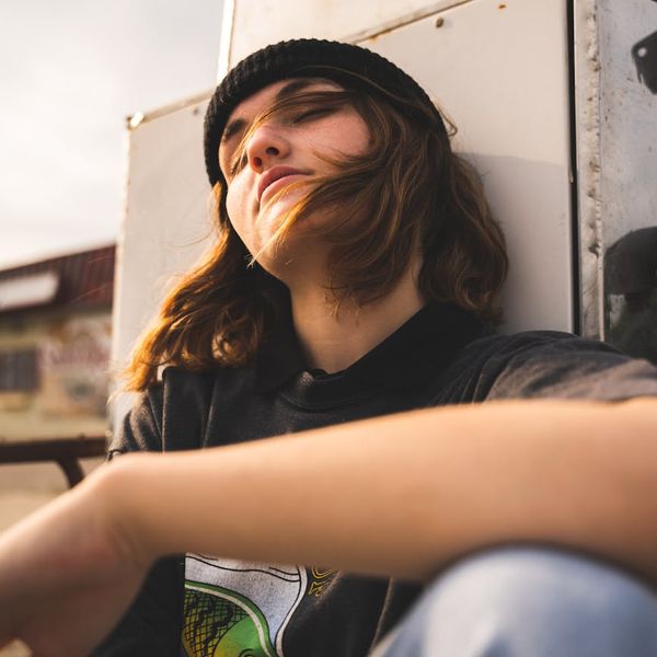 Woman relaxing with her eyes closed in a calm, focused state.